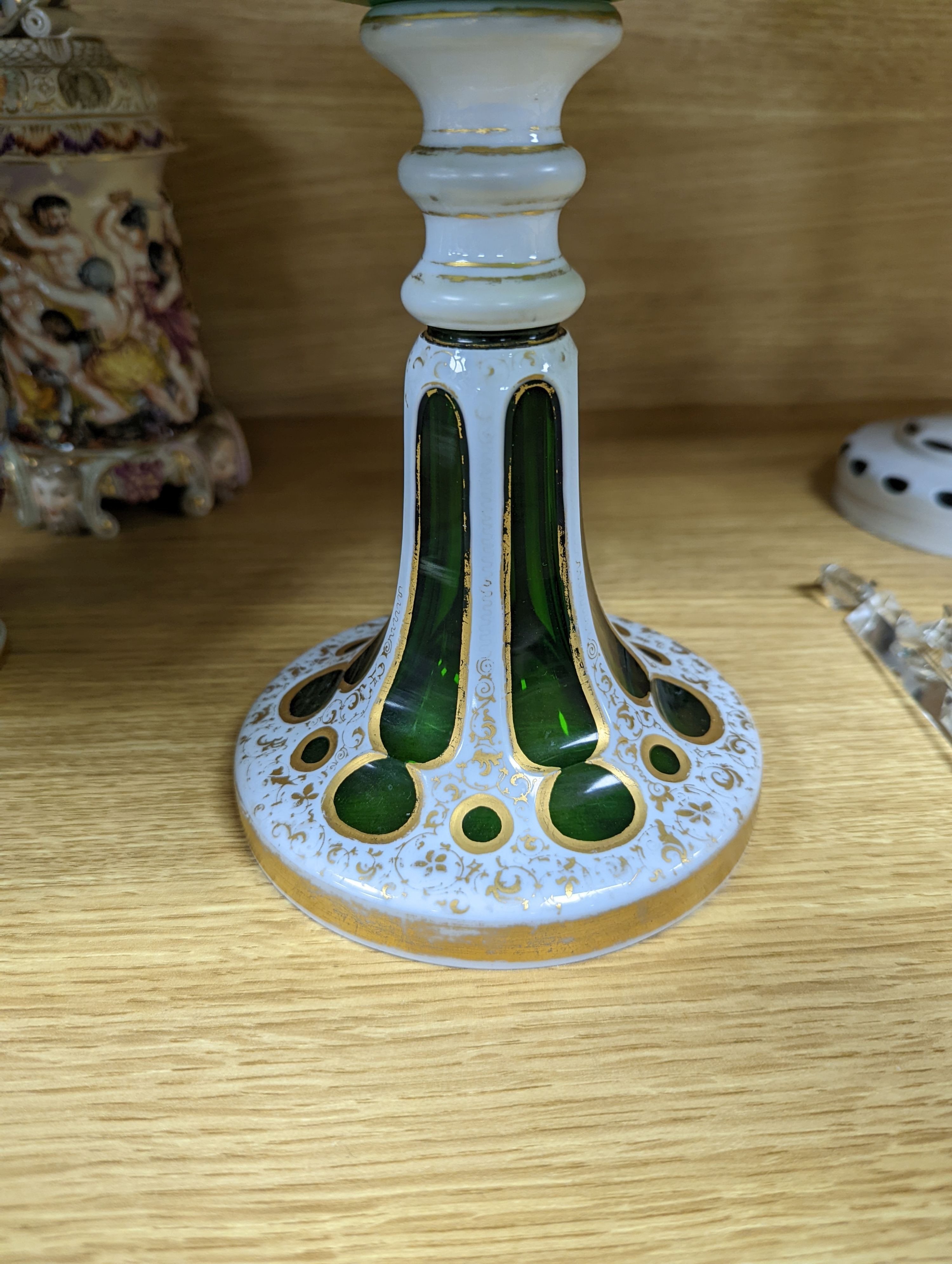 A 19th century overlaid green glass comport, 24cm high, and a similar table lustre